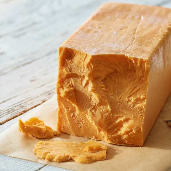 Block of 7-Year Aged Cheddar on a table 
